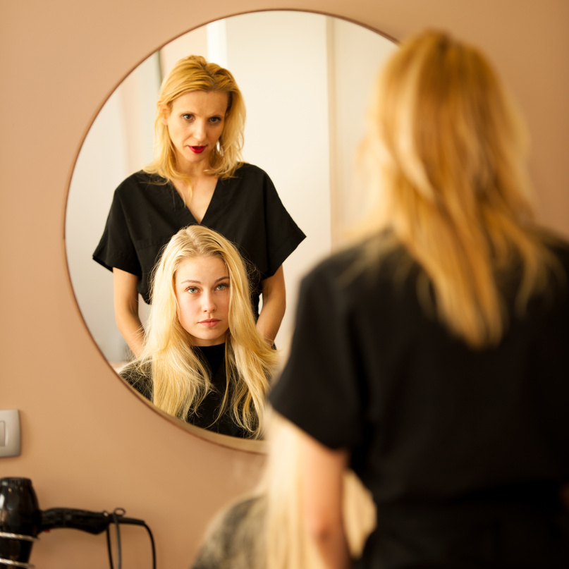 Hair Stylist Consulting a Customer 